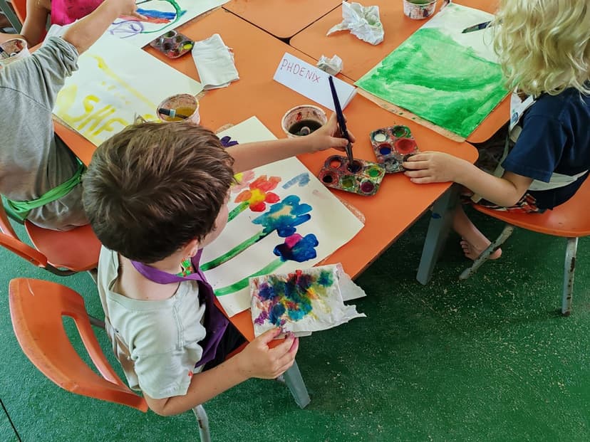 Kids painting at the art table